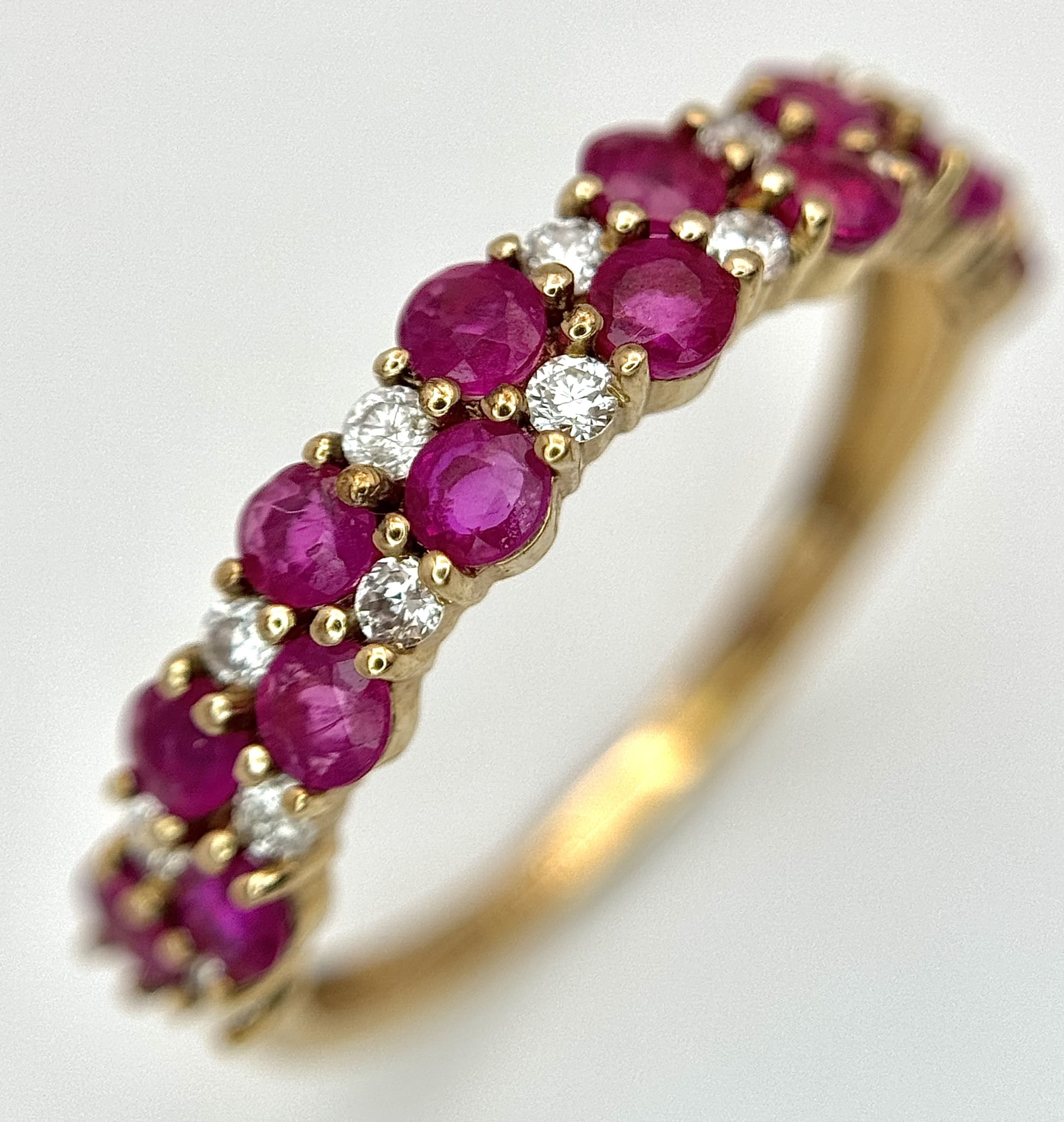 A 9K YELLOW GOLD, DIAMOND AND RUBY SET, 2 ROW RING. 0.20CT WEIGHT. TOTAL WEIGHT 1.5G, SIZE L/M. SC 9010