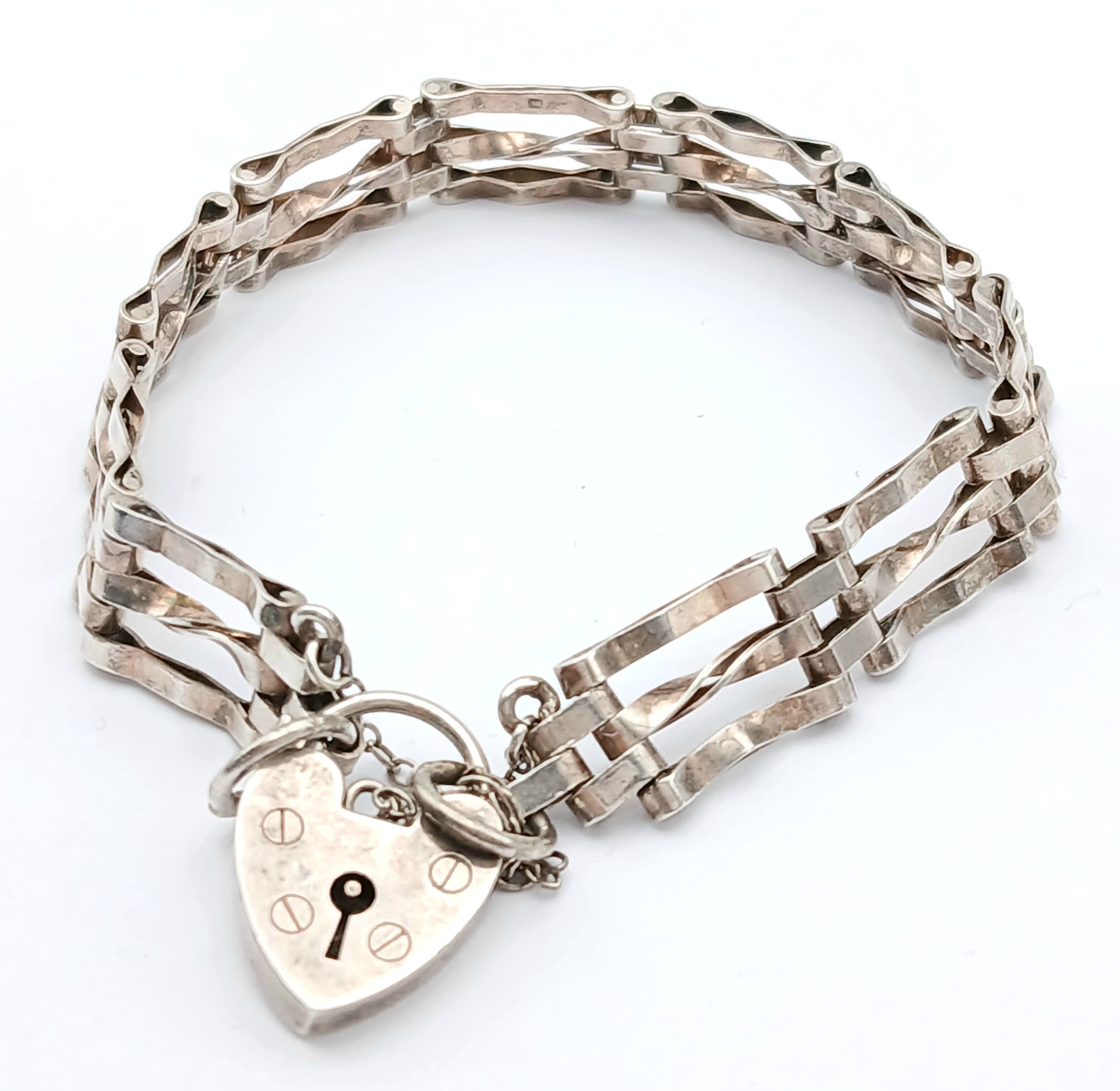 Vintage SILVER ‘GATE’ BRACELET. Consisting a Hallmarked 10 GATE SILVER BRACELET Complete with Safety Chain and Padlock Fastening. Approx 20 cm.