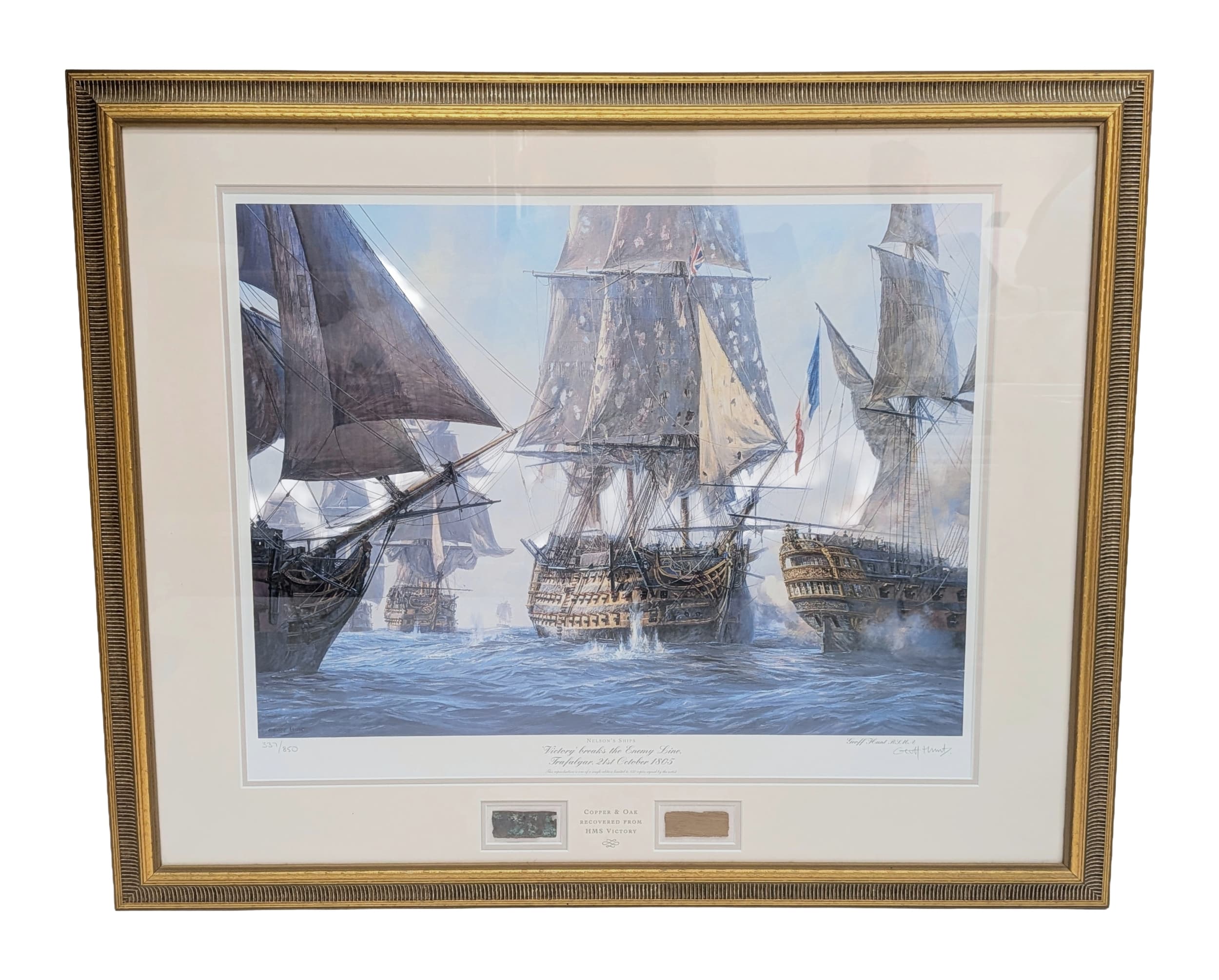 A framed, limited edition print by Geoff Hunt, 'HMS Victory breaks the line' with a peice of copper and oak recovered from the ship. No. 337/850. Very nice condition. Frame is 84cm x 69cm.