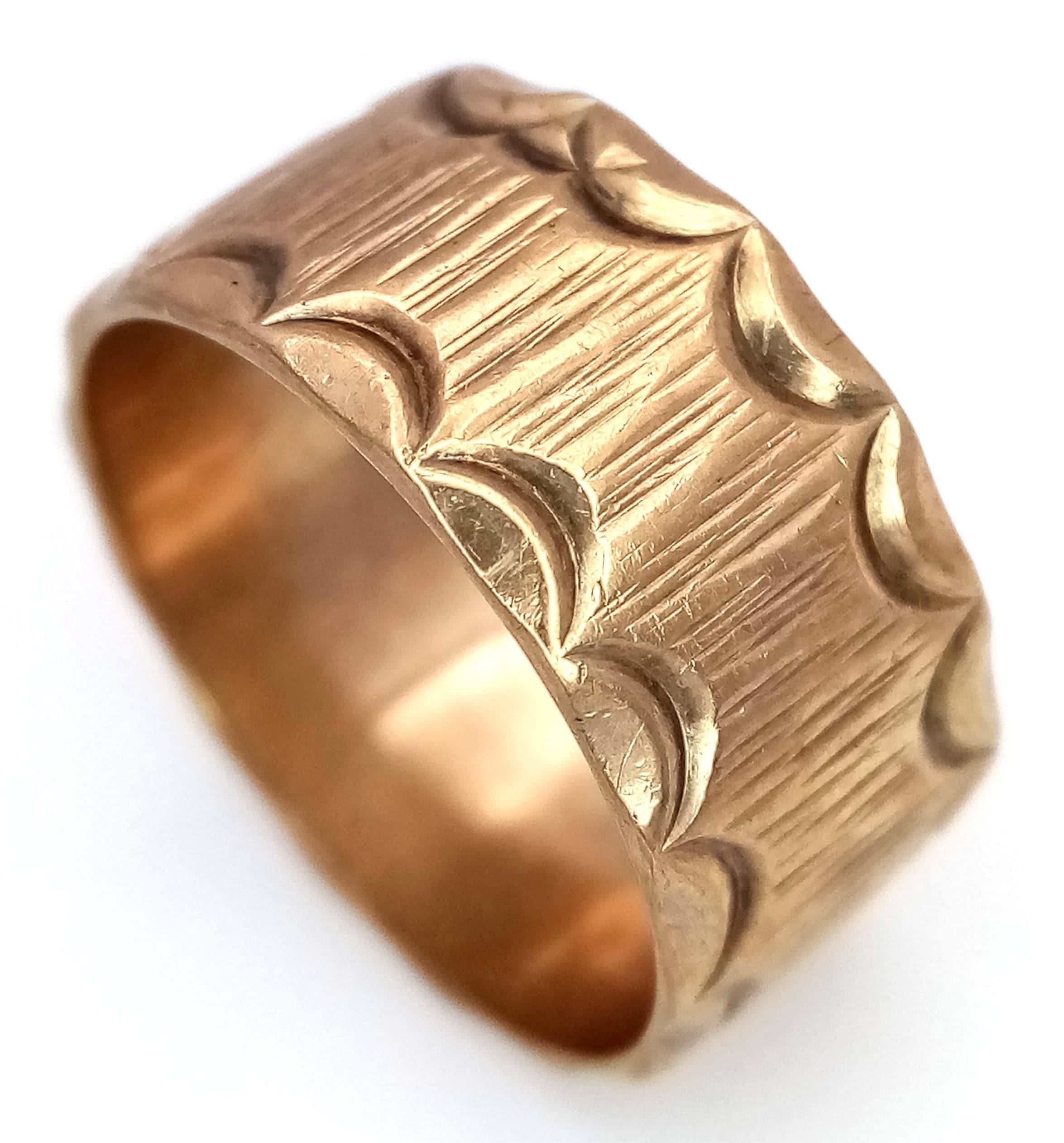 A Vintage Hallmarked 9K Gold Band Ring. Decorative geometric pattern exterior. 9mm width. Size O. 4.95g.