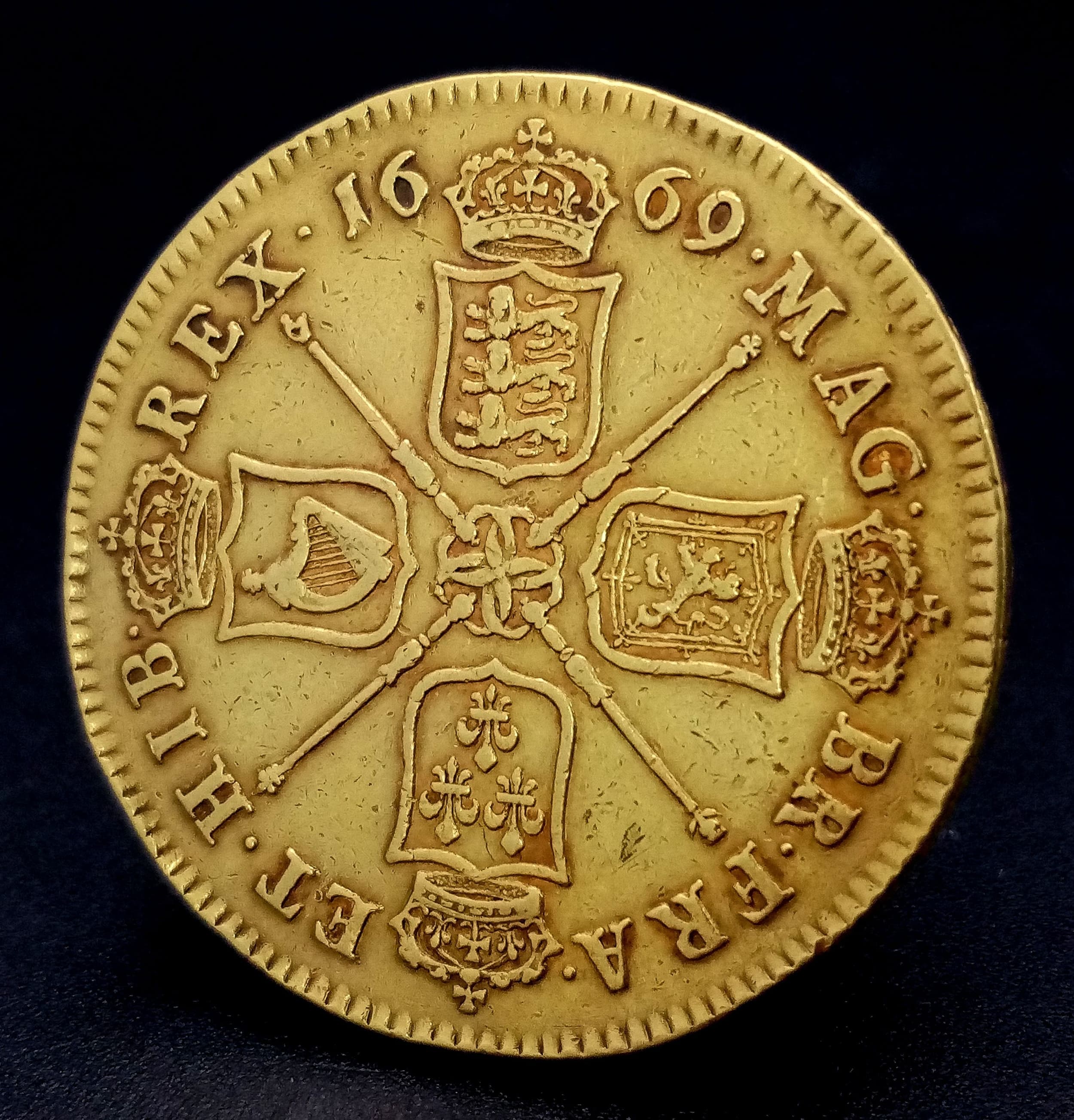 A 1669 Charles II Five Guinea Coin. 22k gold. EF. First bust. Rev. Four crowned shields cruciform. 41.7g. Please refer to photos for finer details.