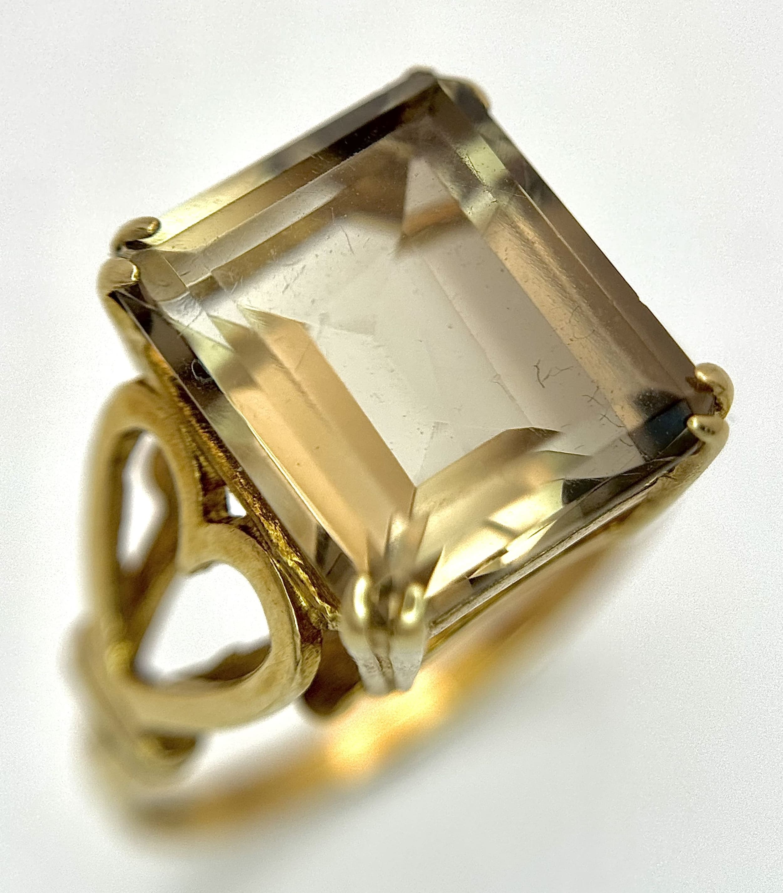A 9K Yellow Gold Smoky Quartz Ring. Step cut rectangular centre stone - 3ct. Size O 1/2. 3.22g total weight.