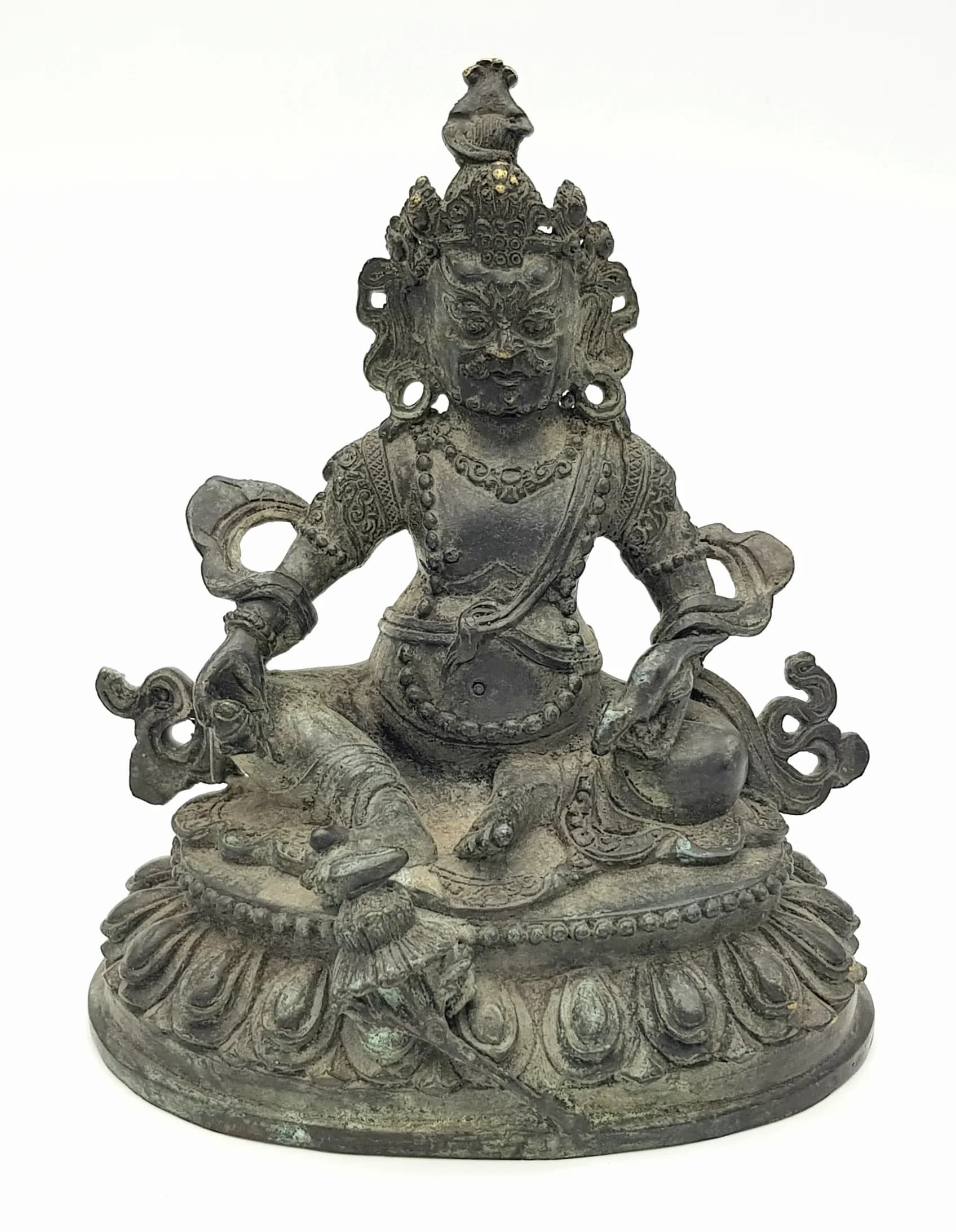 An antique Tibetan Bronze Guardian Deity Figure, .Depicted wearing armor and a jeweled crown, exuding a commanding and majestic presence. Represents a dharmapala (protector deity) in Tibetan Buddhism, symbolizing protection and strength.Base approx. 11.5 cm; Height 14 cm.