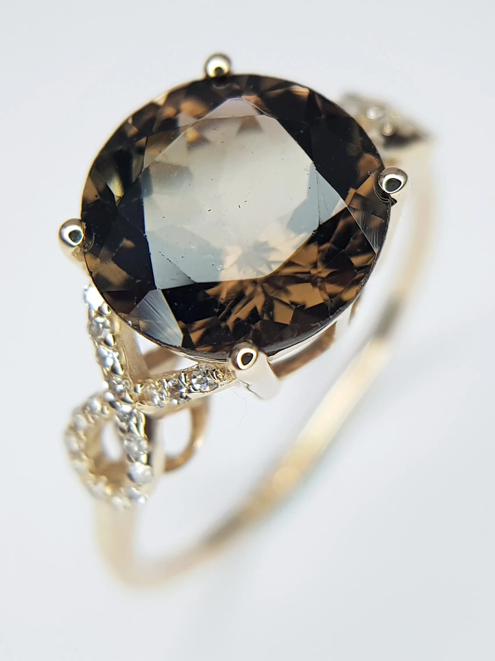 A 14K YELLOW GOLD, 3.50ctw Brazilian Tourmaline Ring with Diamond Accents. A 3.40ct round mixed cut earth-toned tourmaline. Size N 1/2. 2.46g total weight. Comes with an HRD of Antwerp certificate. In Excellent condition. CLR-13080.
