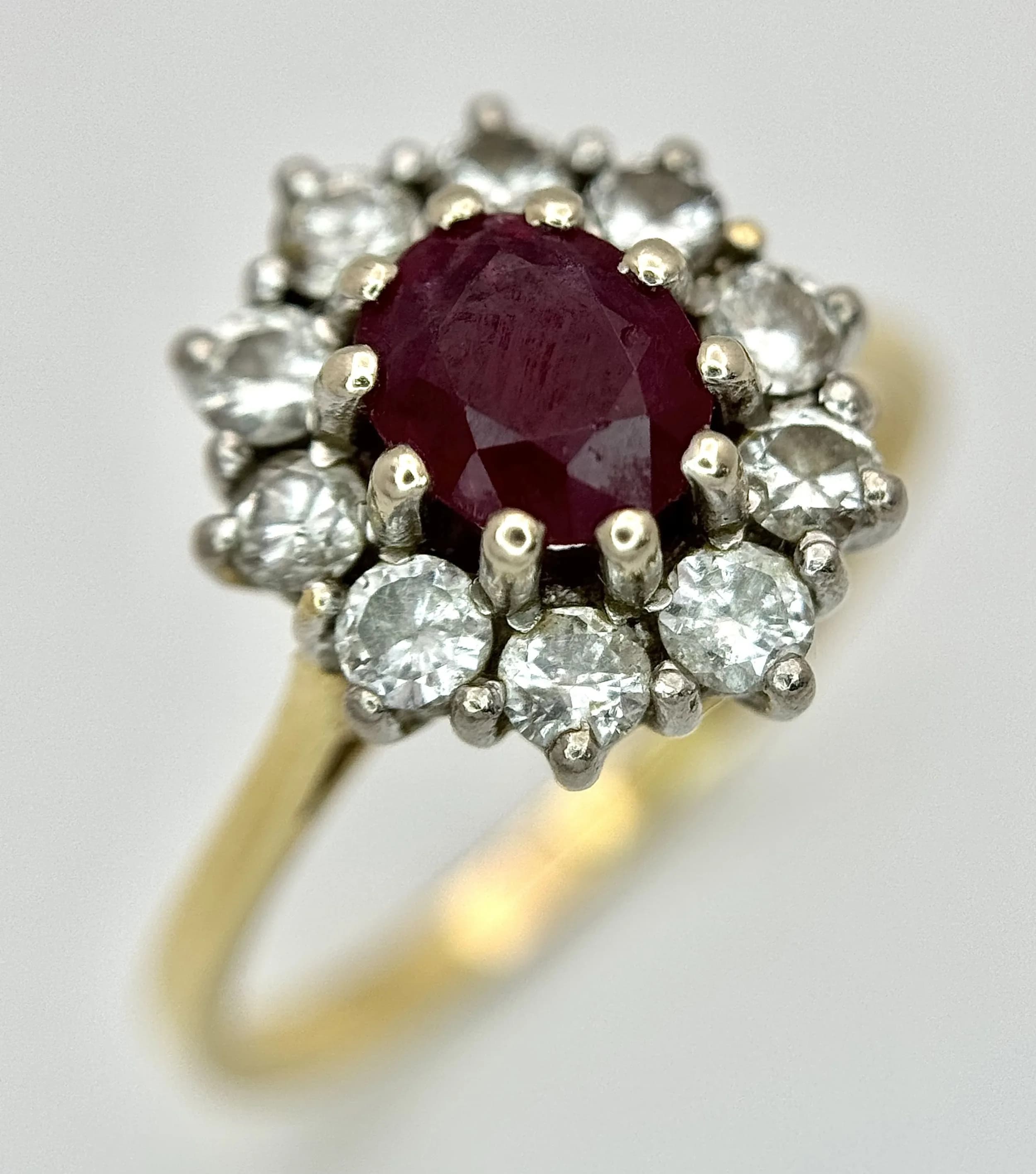 AN 18K GOLD RING WITH RUBY CENTRE STONE SURROUNDED BY QUALITY DIAMONDS . 3.8gms size O/P