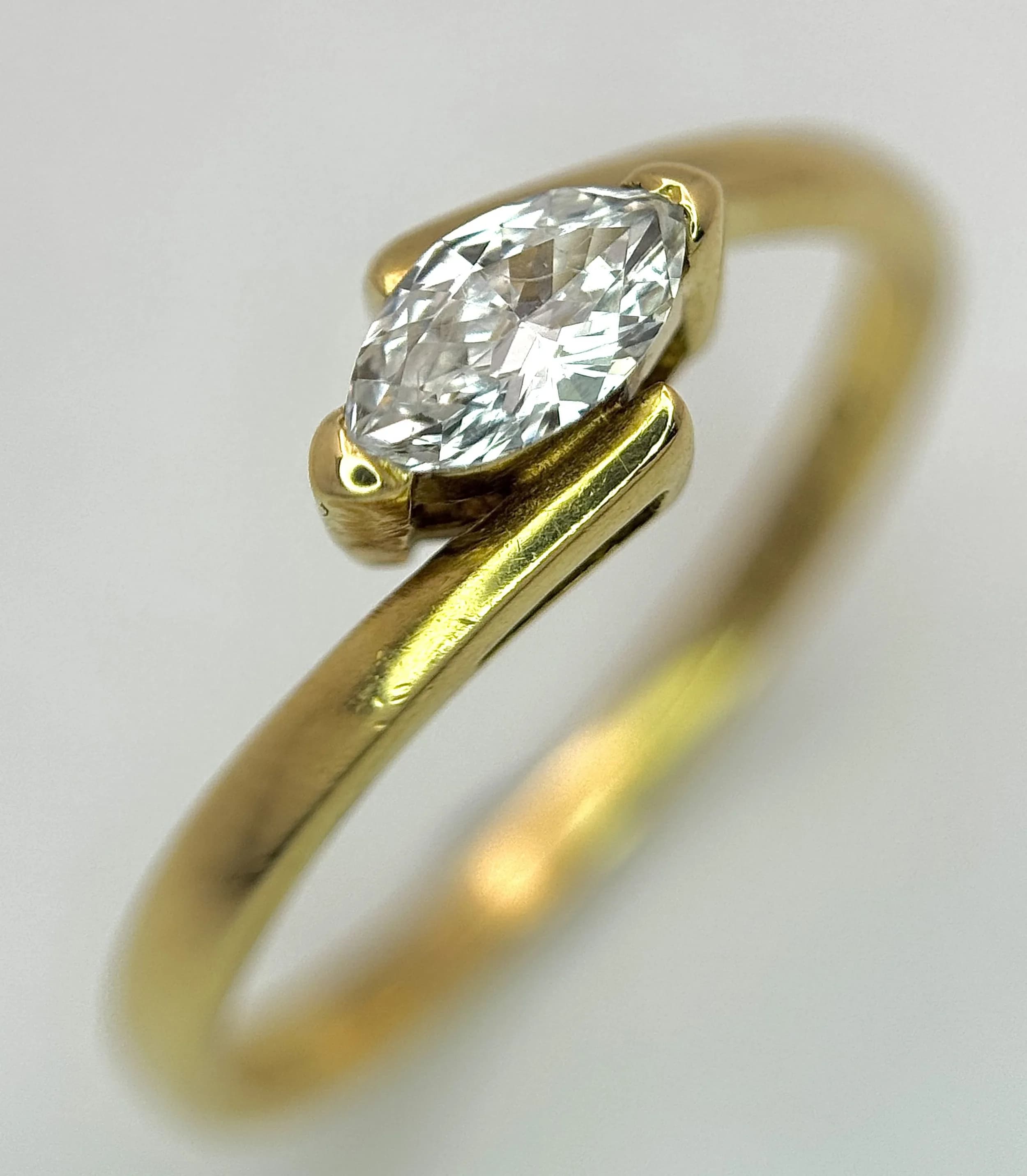 An 18K Yellow Gold Diamond Crossover Ring. Circa 0.35ct marquis cut diamond. Size P. 2.48g total weight. Ref: 2/72006