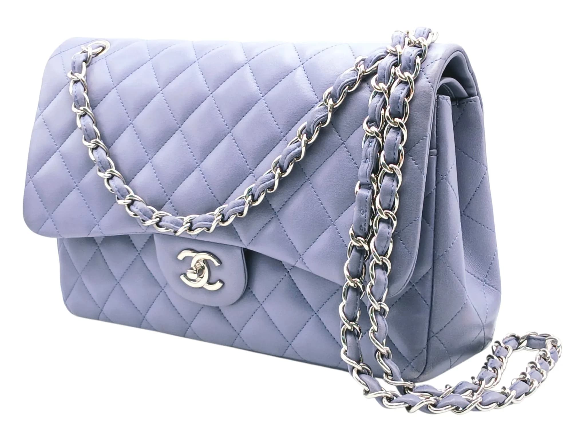 A Chanel Classic Jumbo Quilted Double Flap Bag. Muted lilac diamond-quilted lambskin leather exterior with silver-toned CC turn-lock closure, leather-threaded chain shoulder strap and a rear pocket. The flap opens to a matching leather interior with one main compartment, two open inner side pockets and a partitioned compartment. Comes with authenticity card and dust cover bag. Size approx: 30cm length x 20cm height. Some light wear to the corners and light white marks to the flap, but in good overall condition. Please see photos or request a condition report. Ref: 13245