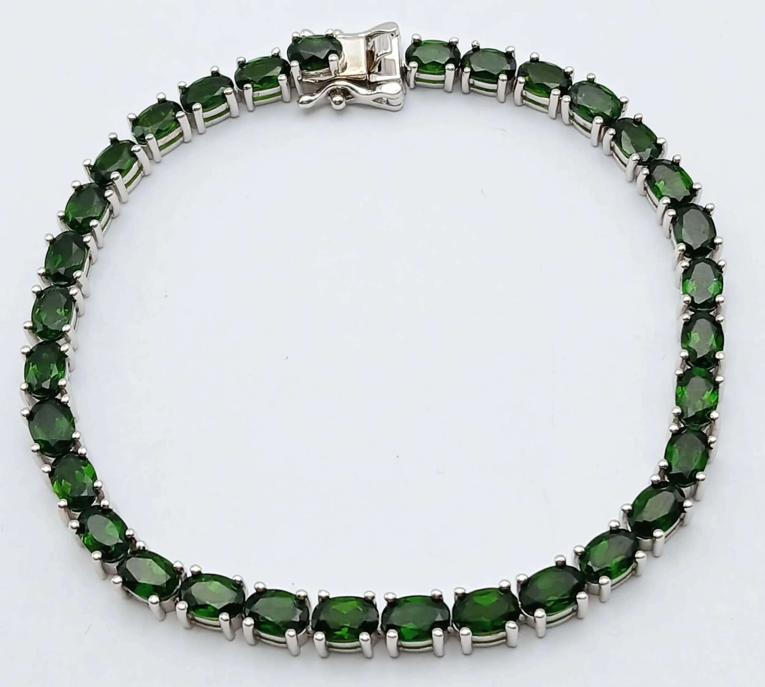 A Stylish Sterling Silver and Green Chrome Diopside Tennis Bracelet-20.5cm Length. 4mm Width. Set with 5mm Length Oval Cut Green Chrome Diopside. Gross weight 16.79 grams.