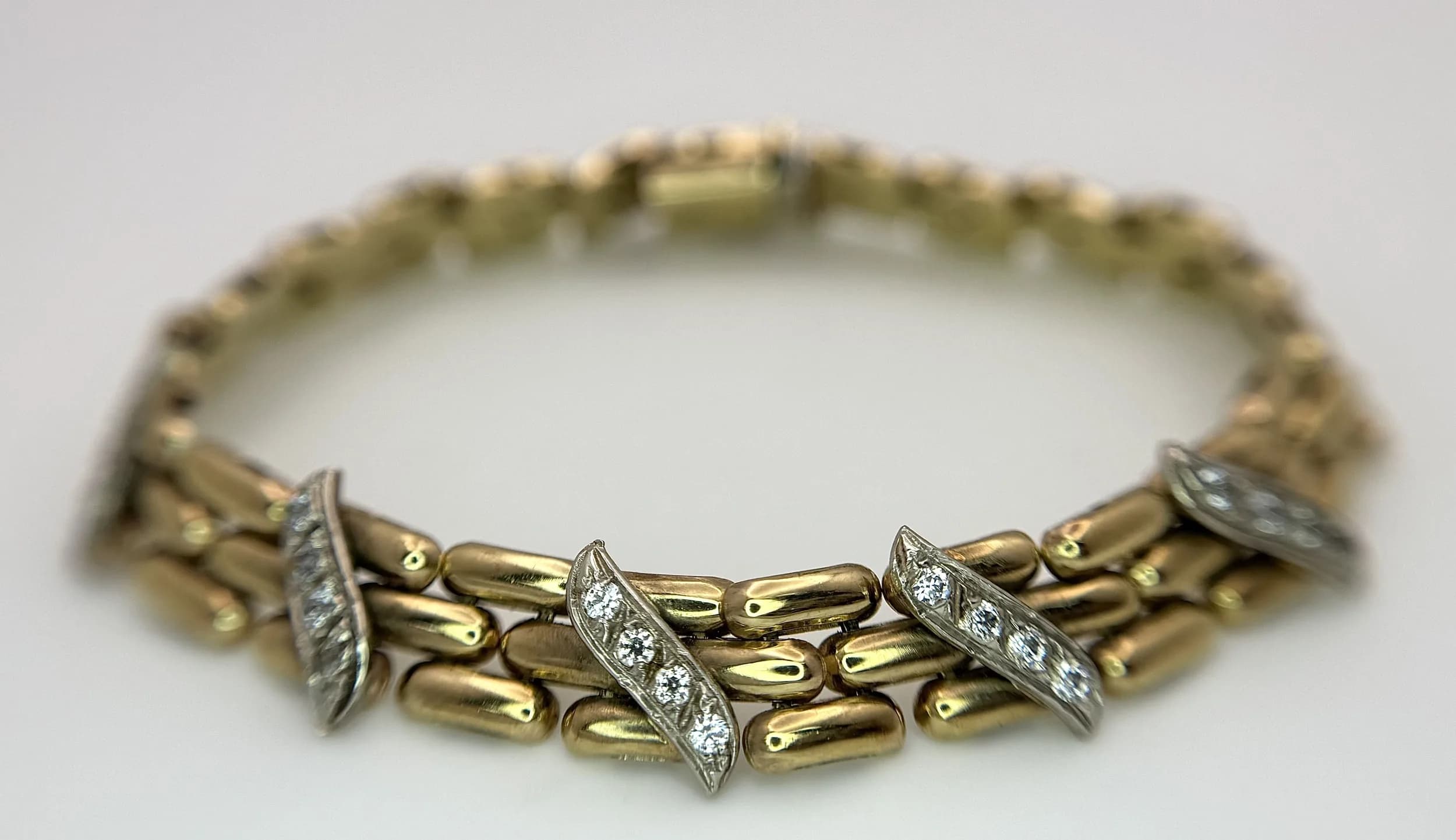 A VINTAGE PANTHER LINK BRACELET IN 9K GOLD FEATURING 5 DIAMOND STUDDED PANELS . 12.9gms 18cms