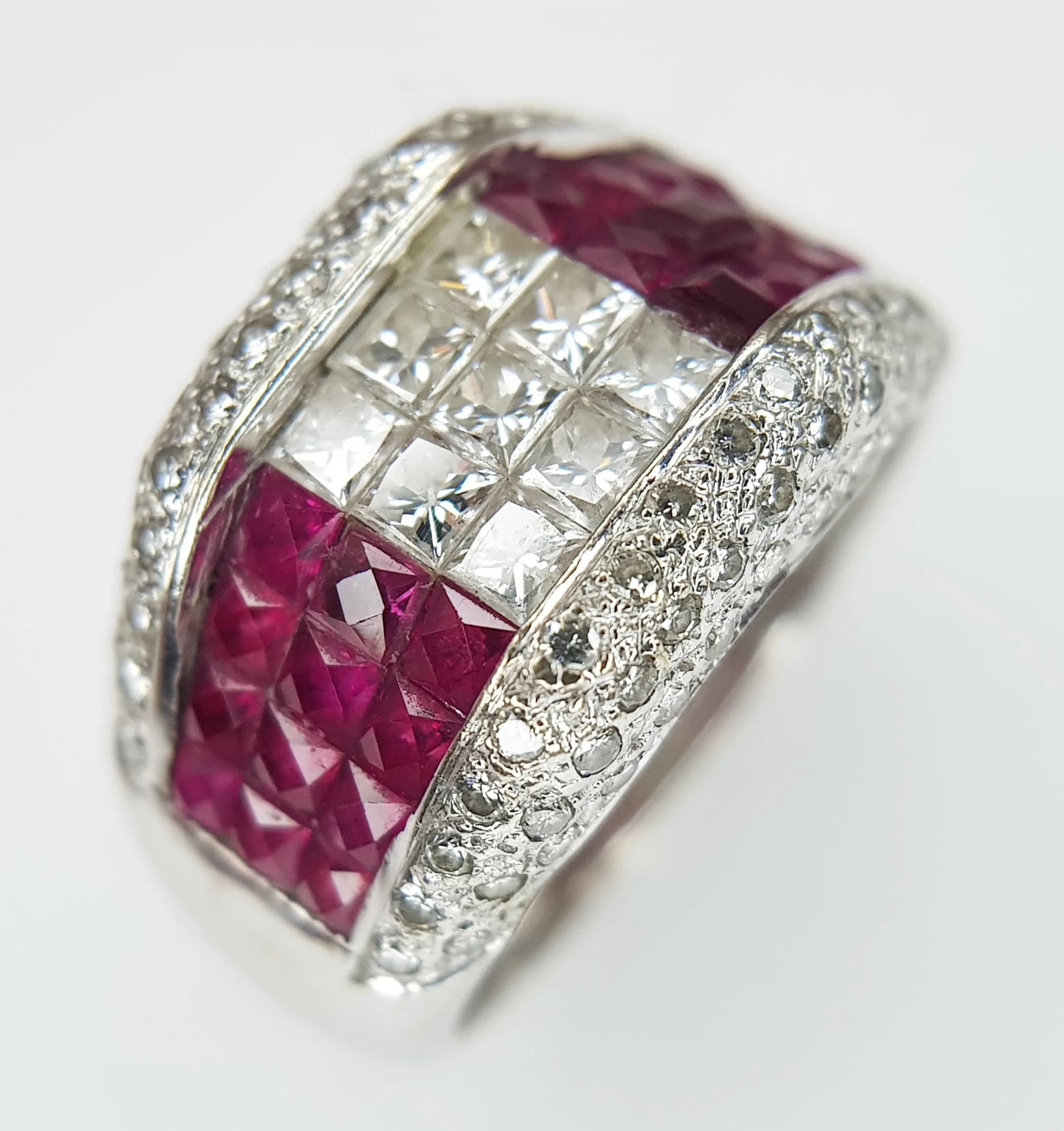 An 18K White Gold, Diamond and Ruby Cocktail Ring. Princess cut stones in a stylish setting. c 1.2ctw of rubies and c.1ctw of diamonds. Size K. 7.9g total weight. Ref: 5.7