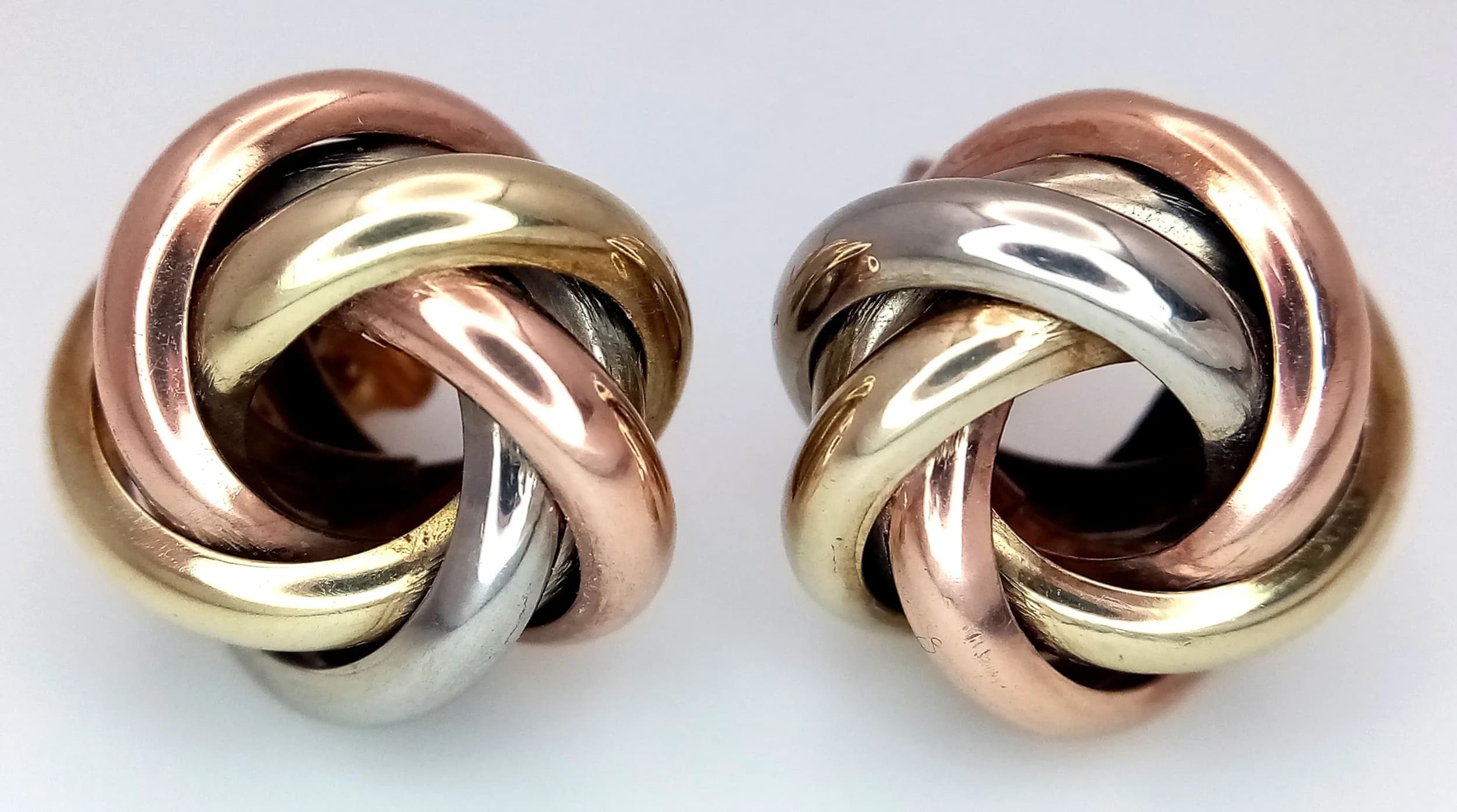 A Pair of Tri-Colour 9K Gold Knot Earrings. 5.35g total weight.
