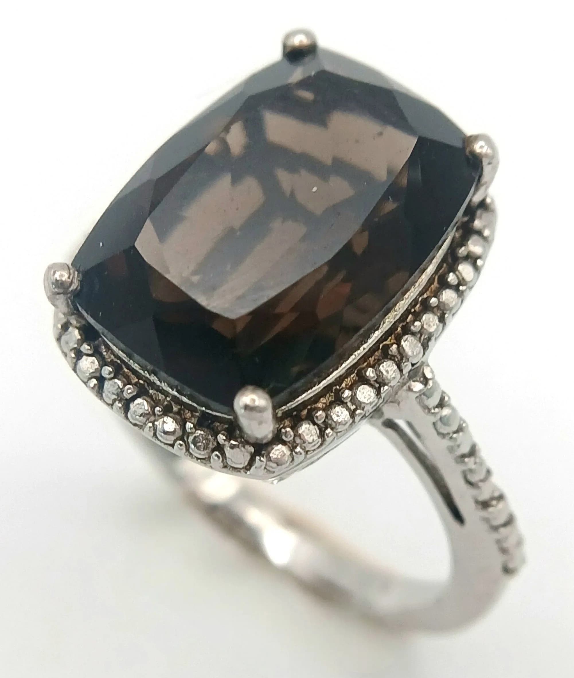 A Vintage Platinum Bonded Smoky Quartz Ring by Karis-Size O. The Ring is set with a 1.5cm Length Smoky Quartz and has a gross weight of 4.48 grams.