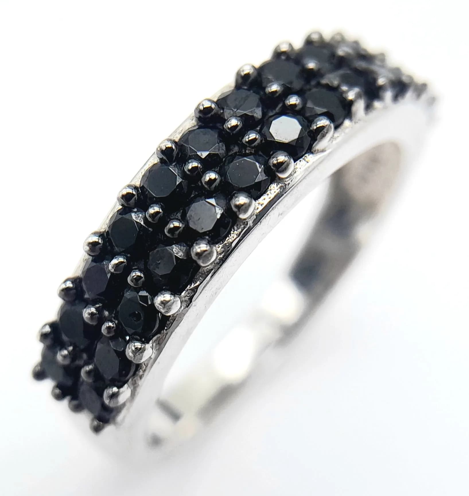 Sterling Silver Double Row Black Onyx Half Eternity Ring. Size N1/2. The Ring measures 6mm wide and has a gross weight of 2.9 grams.