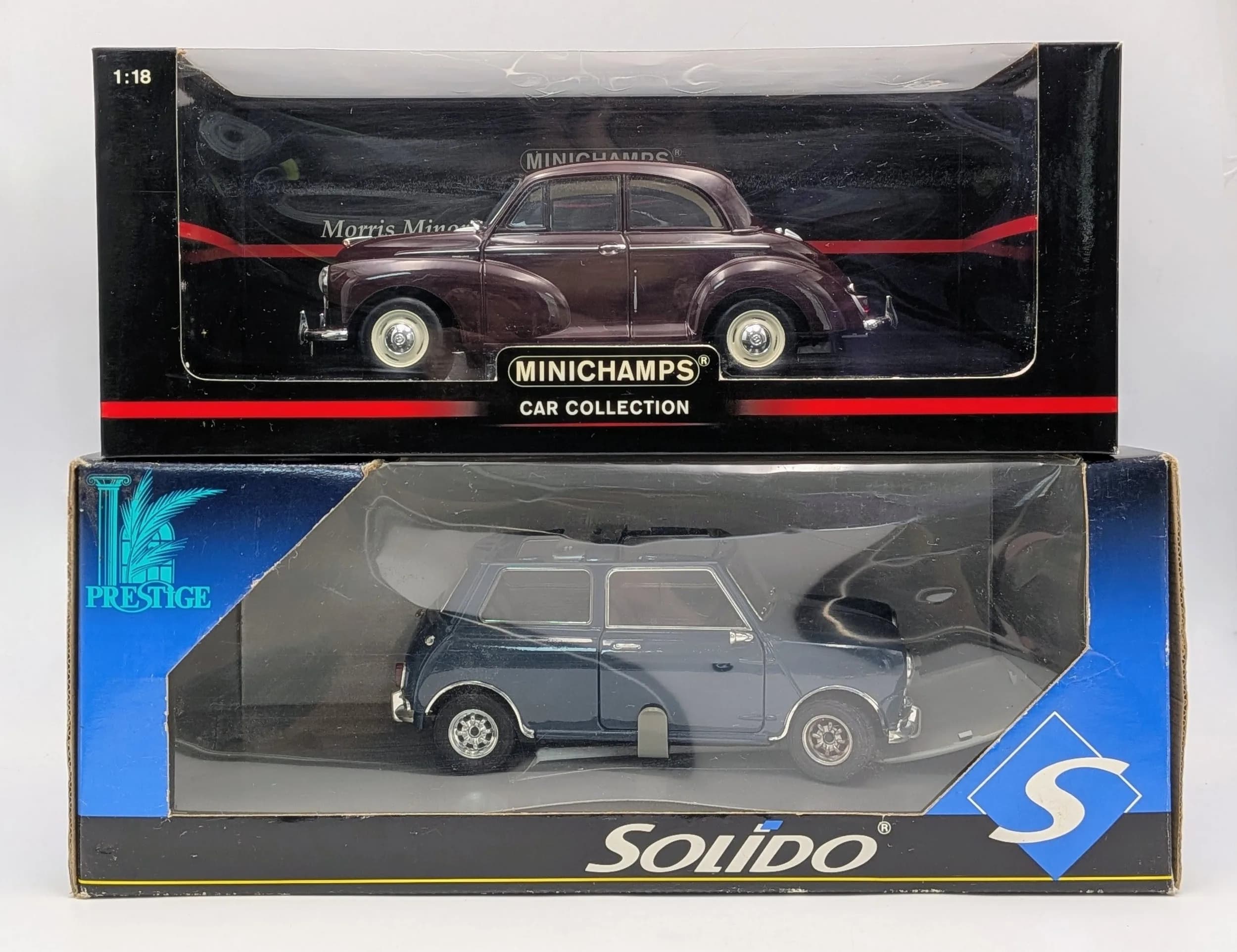 Two 1/18th scale die cast cars. A Solido Mini & a Minichamps Morris Minor. Good condition.