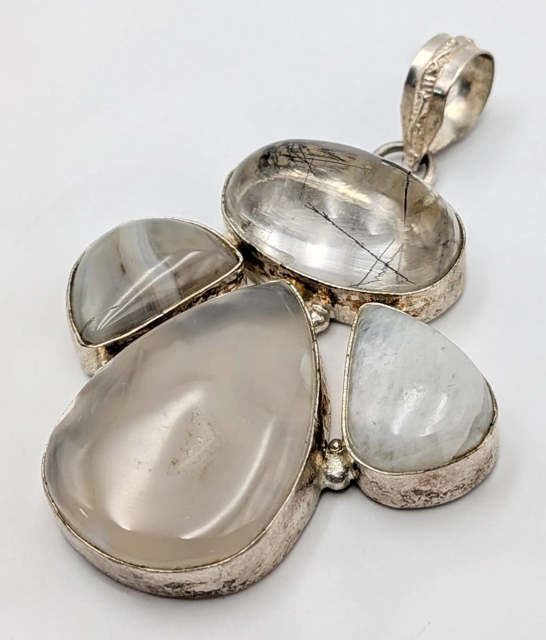 A Sterling Silver Pendant with Moonstone and Rutilated Quartz Pieces