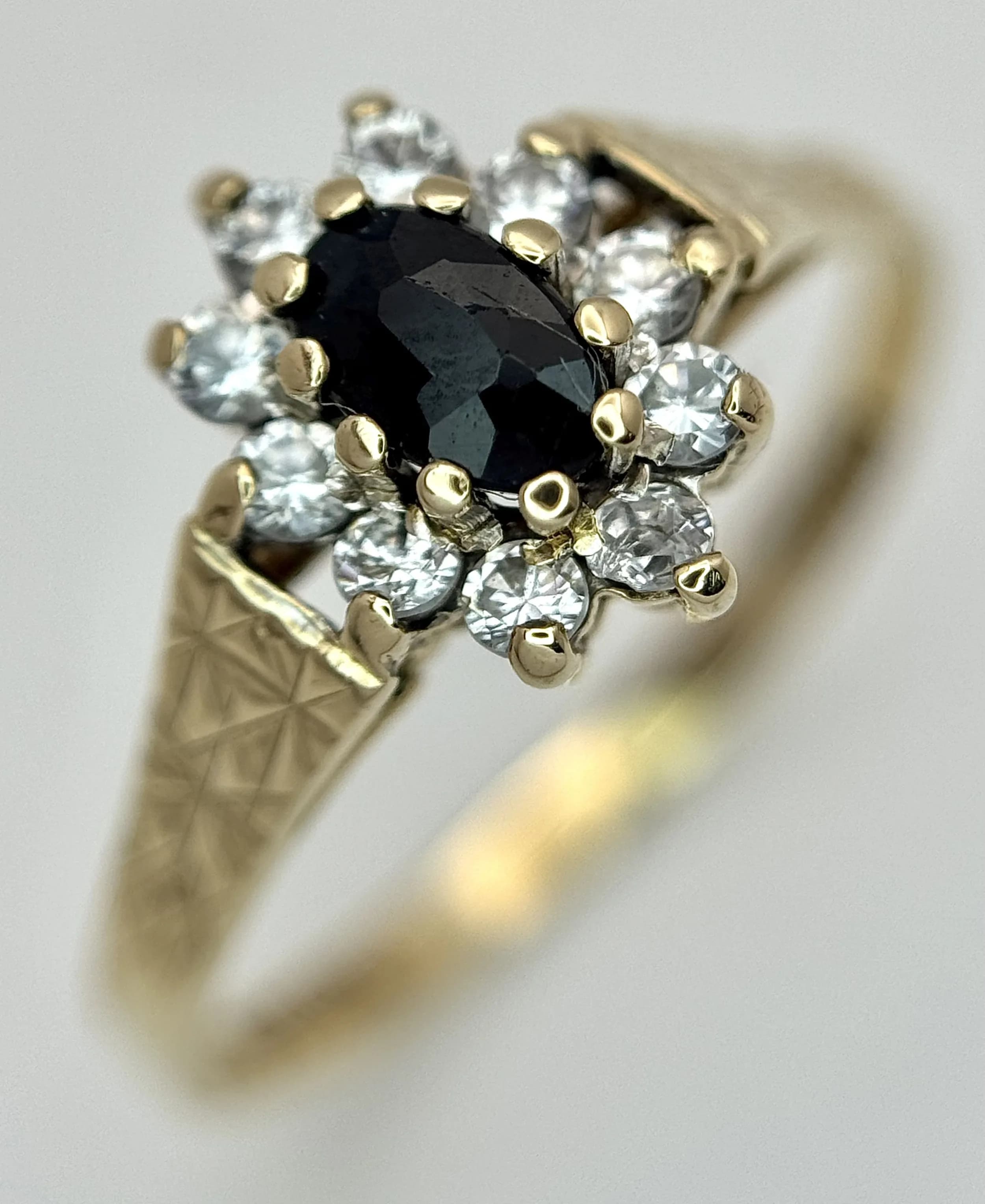 A 9K Yellow Gold Sapphire and Diamond Cluster Ring